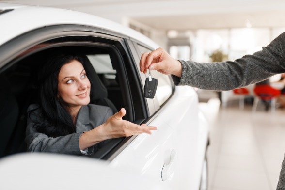 gallery/happy-woman-takes-the-key-to-new-car-in-showroom-gstjkdh
